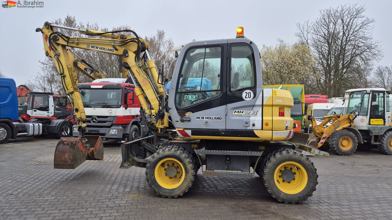 New Holland MH 2.6 Zustand gut, deutsche Maschine incl. Greifer und Dreservo - Колёсный экскаватор: фото 1 New Holland MH 2.6 Zustand gut, deutsche Maschine incl. Greifer und Dreservo - Колёсный экскаватор: фото 1