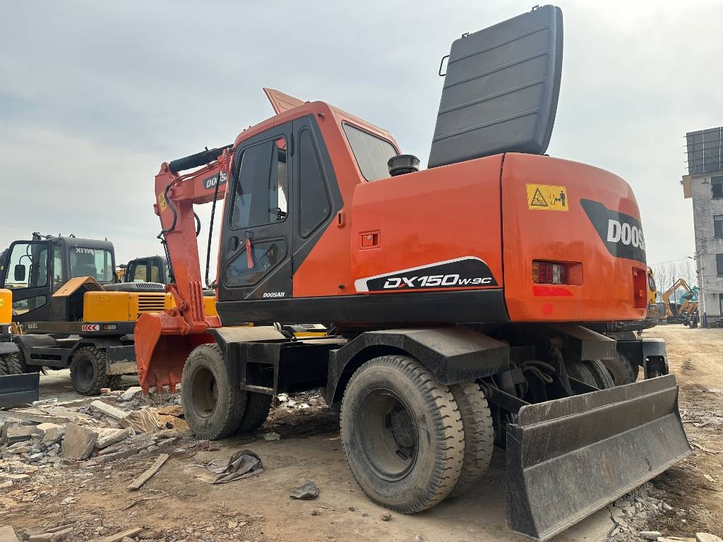 Doosan DX 150W -9 - Колёсный экскаватор: фото 1 Doosan DX 150W -9 - Колёсный экскаватор: фото 1